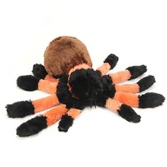 an orange and black spider plush toy on a white background