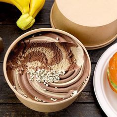 an assortment of desserts are displayed in bowls on a table with bananas and other items