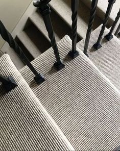 an up close view of some stairs with metal handrails and carpeted steps