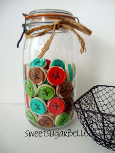 a jar filled with lots of different colored buttons