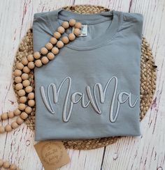 Classy gray on gray Mama tee with 3D puff embroidery!  The perfect tee for any Mama! Made with LOVE in Oklahoma.   Comfort Color 6.1 oz 100% ring spun cotton. Unisex sizing for a relaxed fit. Suggested sizes: S (0-4) M (6-10) L (10-14) XL (14-18) *Processing TIme* Please allow 5-7 days for production.  We ship USPS, normally allow up to 7 days for shipping. *Care Instructions* Wash inside out, cold.  Lay flat to dry.  Lightly iron if necessary, but NOT over the embroidery Return/Exchange Policy: All sales are final, due to the custom nature.  Please message me with any questions BEFORE purchasing. Casual T-shirt With Embroidered Text For Mother's Day, Gray Cotton Tops With Letter Embroidery, Gray Cotton Top With Letter Embroidery, Casual Gray Tops With Embroidered Text, Casual Gray Top With Embroidered Text, Gray Embroidered Text Crew Neck Top, Embroidery Mothers Day, Puff Embroidery, Embroidery 3d