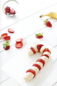 strawberries and bananas are arranged in the shape of a caterpillar