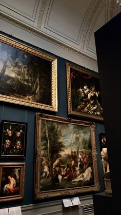 many paintings are hanging on the wall