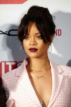 a close up of a person wearing a shirt and necklace