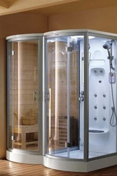 a bathroom with a walk in shower next to a window and wooden floored walls