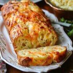 a loaf of cheesy bread sitting on top of a white plate