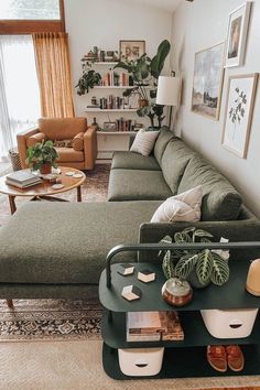 a living room filled with furniture and lots of plants on top of a coffee table