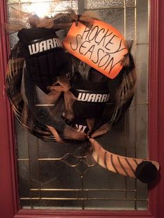 a hockey wreath on the front door of a house that has been decorated for halloween