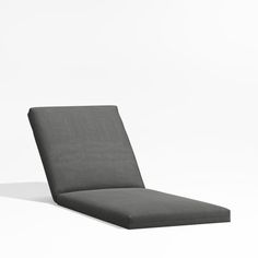 a gray lounge chair sitting on top of a white floor