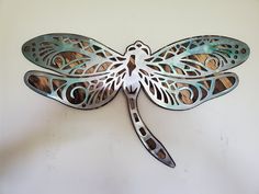 Beautiful Dragonfly metal and wood wall sculpture, the perfect addition to any home looking for a unique piece of metal art home decor. This sculpture is made in our family shop in Minnesota, using rustic stained wood and clear-coated steel. The dragonfly cutout is delicately detailed to highlight the beautiful wood grains beneath it, and the steel reflects light, mimicking the sun's rays just like a dragonfly dashing in flight between flowers and trees.This wood and metal wall sculpture is desi Dragonfly Dragon, Dragonfly Sculpture, Art Pallet, Art Dragonfly, Metal Dragonfly, Pallet Frames, Dragonfly Wall Decor, Metal Art Wall, Dragonfly Wall Art