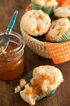 a wooden table topped with small bowls filled with food and a jar of peanut butter