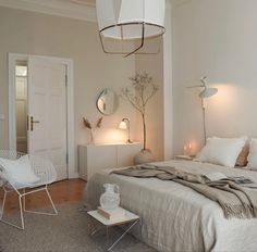 a bedroom with a large bed and white furniture