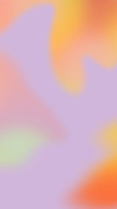 a blurry image of an orange and pink background