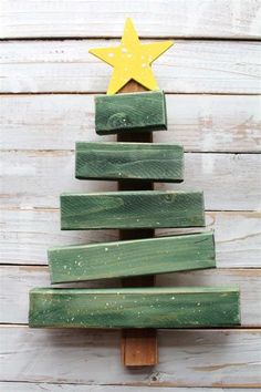 a christmas tree made out of wooden planks on top of a white wood wall