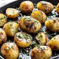 cooked potatoes with herbs and seasoning in a cast iron skillet, ready to be eaten