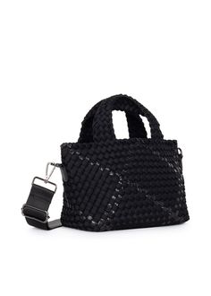 The Haute Shore Mark Noir is a small sized terylene woven tote featuring a black body with metallic accents. Woven textile body with white and olive accents. Lined interior. Top zipper closure. One slip, and one interior zip pocket. 4 inch main handle strap drop. Includes a removable wristlet pouch w/zipper and hand strap. Includes a 2 inch fully adjustable crossbody strap. Dimensions: 14" long x 8" tall x 4" deep. Washable with mild soap. Hang dry. Body Dimensions, Noir Color, Neoprene Bag, Wristlet Pouch, Neoprene Tote, Coverlet Bedding, Weaving Textiles, Silk Pillowcase, Mini Tote