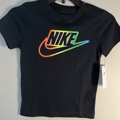 Boys Black And Neon Nike T-Shirt. Never Worn Black Nike T-shirt With Letter Print, Nike Black T-shirt With Letter Print, Multicolor Logo Print Short Sleeve Tops, Multicolor Short Sleeve Tops With Logo Print, Casual Multicolor Logo Print T-shirt, Casual Multicolor T-shirt With Logo Print, Multicolor Graphic Tee With Logo Print, Nike Short Sleeve T-shirt With Graphic Design, Trendy Nike T-shirt With Letter Print