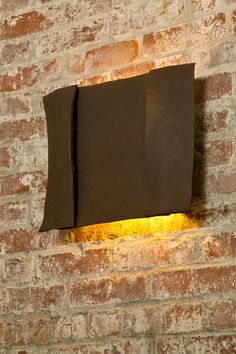 a light that is on the side of a brick wall