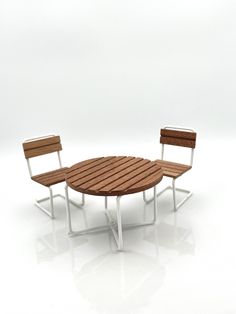 two chairs and a table made out of wood