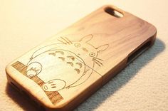 a wooden phone case with an image of a cartoon character on the front and back