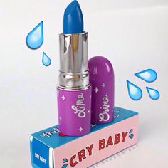 a blue and purple lipstick sitting on top of a box