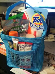 a blue bag filled with various items on top of a desk