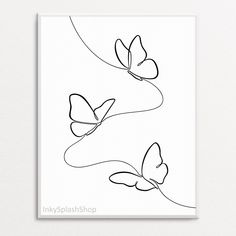 two butterflies are flying in the air on a white background, one is drawn with black ink