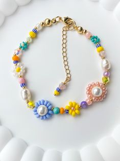 The Laura beaded bracelet is colorful and fun! The perfect gift for any woman, friend, sister, daughter, etc. 100% handmade using the best materials.  FEATURES:  * Seed beads sizes 2 to 4mm, freshwater pearls 5-7mm, natural stones 4mm, crystals 4mm, and crystal faux pearls (inside the 2 bigger flowers).  * 18k Gold Plated Lobster clasp and findings. * Made with love and care. LENGHT: Choose between 6.5 or 7 inches + Each bracelet comes with a 1 inch extender chain CARE INSTRUCTIONS: *Remove befo Playful Handmade Beaded Bracelets For Spring, Playful Beaded Bracelets As Spring Gifts, Handmade Flower Bracelets For Birthday, Flower-shaped Friendship Bracelets With Colorful Beads For Gifts, Flower Shaped Friendship Bracelets With Colorful Beads As Gift, Multicolor Flower Friendship Bracelets As Gift, Playful Bracelets With Colorful Beads For Spring, Adjustable Daisy Beaded Bracelets Gift, Playful Bracelet With Colorful Beads For Spring