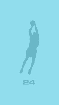 a basketball player jumping up to dunk the ball with his shadow on the wall