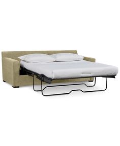 a sofa bed with a pull out mattress on it's side and two pillows on the back