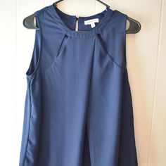 Nwot, Has Never Been Worn, Monteau Navy Blue Blouse, Size Medium. This Top Is A Very Cute Top That Is Perfect For Dressing Up, For Work, Or For Business Attire. It's Flowy And Has A Button On The Back For Closure. The Collar Bone Area Has Cut-Outs As Part Of The Design. This Top Has The Potential To Fit Someone Who Wears A Size Large Normally. I'm A Size Medium And It Was A Bit Big For Me. Please Reference The Measurements To Ensure Proper Fitting. Armpit To Armpit Is Approx. 17.5" Elegant Navy Sleeveless Top, Navy Sleeveless Top For Work, Sleeveless Blue Blouse For Work, Navy Blue Blouse, Business Attire, Cute Tops, Navy Blue, Top Blouse, Dress Up