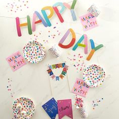 happy birthday decorations and confetti on a table