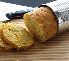 two pieces of bread sitting on top of a cutting board next to a knife