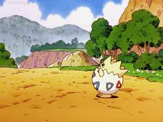 the pokemon is standing in front of some mountains