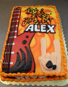 a birthday cake with an image of a guitar and the words alex written on it