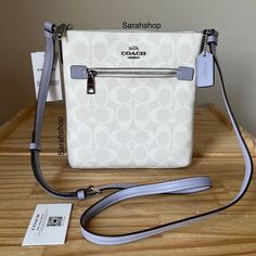 100% Authentic Brand New With Tags Bag Comes In Original Packaging Cf340 Signature Mini Rowan File Crossbody Bag Mist And Silver Hardware Approximate Dimensions: 8” L X 8” H Adjustable Strap Designer White Shoulder Bag With Zipper Closure, Navy Handbag, Coach Crossbody Purse, Crossover Bags, Convertible Crossbody Bag, Drawstring Bucket Bag, Small Crossbody Purse, Coach Crossbody Bag, Black Leather Purse