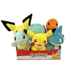 pokemon stuffed animals in a box on a white background