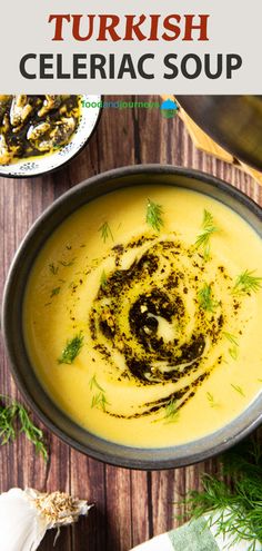 a bowl filled with soup and topped with parsley in the middle, on top of a wooden table