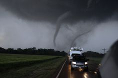 a large tornado is coming down the road