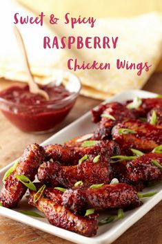 sweet and spicy raspberry chicken wings on a white platter with dipping sauce