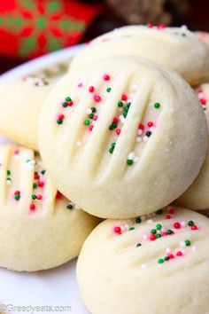 some cookies with sprinkles on a white plate