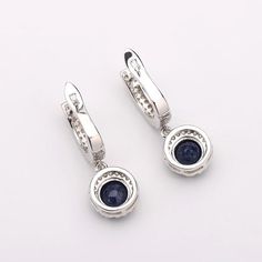 Elegant Sterling Silver Blue Sapphire Halo Pendant Earrings Enhance your elegance with these stunning natural blue sapphire drop earrings. Crafted from high-quality 925 sterling silver, these earrings feature a beautiful cubic zirconia pave inlay that adds a touch of sophistication. Luxurious Design These earrings are the perfect luxurious and classy addition to any outfit. Their round cut blue sapphires, totaling 3-2/3 ct. t.w., create a captivating halo effect that sparkles with every movement Blood Diamonds, Smoky Quartz Jewelry, Blue Sapphire Gemstone, Vintage Jewelry Sets, Blood Diamond, Sterling Silver Charms, Halo Pendant, Quartz Jewelry, Luxurious Design