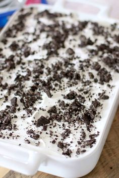 an ice cream dish with chocolate chips on top and white frosting in the middle