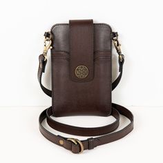 Crafted with the design DNA of equestrian heritage, the Austin Deep Brown Phone Tote is a perfect blend of elegance and functionality. Made from luxurious Italian leather, this phone wallet effortlessly transforms into a crossbody leather bag with an adjustable strap. The Horseshoe Medallion snap secures a phone sleeve with hidden credit card slots, while the reverse side offers additional storage. Finished with a functional and stylish easy wear, Austin is designed for the modern equestrian lif Equestrian Outfits Casual, Modern Equestrian, Lucky Horseshoe, Card Sleeves, Elegant Bags, Equestrian Outfits, Deep Brown, Signature Print, Equestrian Style