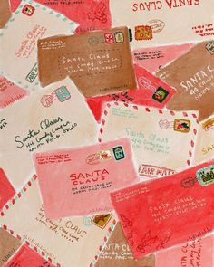 many different types of envelopes are on the table with red and pink paper around them