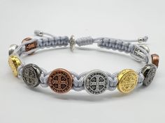 Catholic bracelet with 10 St Benedict medals, in silver, bronze and gold color. Adjustable bracelet by two inches. Choose your cord color and size in dropdown menu. CONTACT US FOR SPECIFIC SIZE. Enter your 10 medals from photos for your bracelet. Bracelet is handmade to order, in Medjugorje, BiH. ------------------------------------------ The bracelet is packed in a transparent plastic bag with a Medjugorje motif on it. Custom gift card available for FREE - at the checkout - just send the text y Silver Spiritual Resizable Friendship Bracelets, Spiritual Silver Resizable Friendship Bracelets, Nickel-free Silver Braided Bracelet For Friendship, Silver Spiritual Friendship Bracelets, Handmade Silver Rosary Bracelet For Friendship, Adjustable Silver Metal Rosary Bracelet, Adjustable Silver Rosary Bracelet With Charms, St Benedict Bracelet, Catholic Bracelet