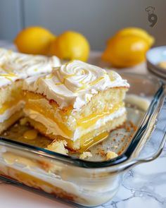 a close up of a piece of cake on a plate with lemons in the background