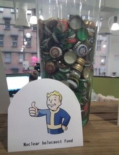 a glass jar filled with lots of beer bottle caps next to a sign that says nuclear holocust fund