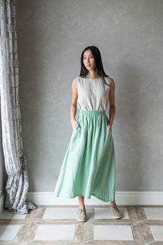 "This linen maxi skirt is the perfect addition to any wardrobe. Crafted from high-quality linen, this long skirt is both comfortable and durable, ensuring that it will be a staple in your wardrobe for years to come. Featuring an elastic waist and two side functional pockets, the MERIDA linen skirt is designed for maximum comfort and ease of wear. The elastic band allows for a customizable fit, making it perfect for all body types. And with its long length, this linen skirt provides plenty of cov Green Linen Relaxed Fit Skirt, Linen Green Lined Skirt Bottoms, Green Linen Lined Skirt Bottoms, Green Linen Maxi Skirt For Summer, Summer Green Linen Maxi Skirt, Green Linen Lined Skirt, Gathered Linen Maxi Skirt, Linen Maxi Skirt With Elastic Waistband, Green Linen Maxi Skirt