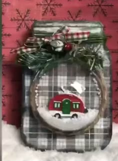 a glass jar with a christmas ornament hanging from it